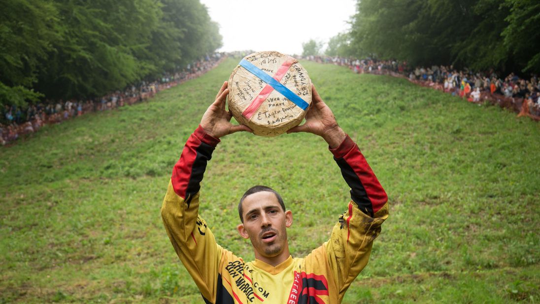 Competitors tumble down hill at annual United Kingdom cheese-rolling race