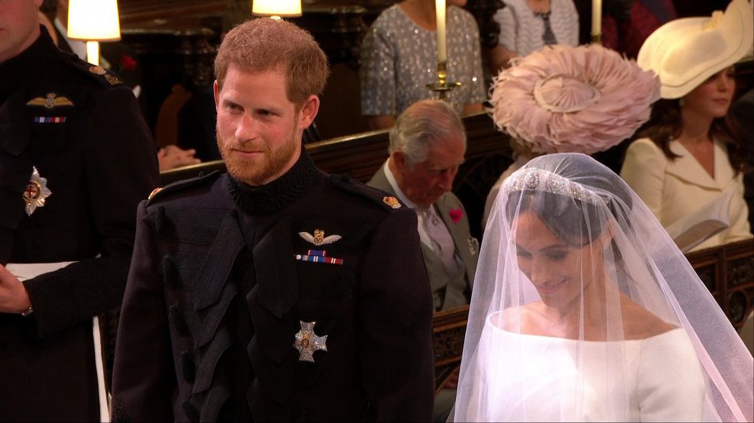 Prince Harry and Meghan Markle smile at the alter