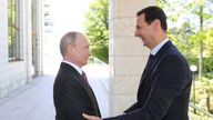 Vladimir Putin welcomes Syrian President Bashar al-Assad during their meeting in the Black Sea resort of Sochi, Russia