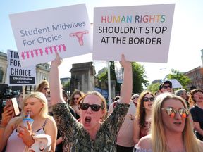 People attend a People Before Profit protest calling of for provision of Abortion in Northern Ireland, at Belfast City Hall.