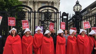 Protesters in costumes similar to those in TV drama The Handmaid's Tale