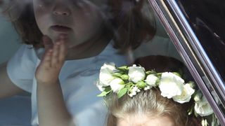 A flower girl waves to the crowd as she rides in a car to the wedding at St George's Chapel in Windsor Castle of Prince Harry and Meghan Markle. PRESS ASSOCIATION Photo. Picture date: Saturday May 19, 2018. See PA story ROYAL Wedding. Photo credit should read: Andrew Milligan/PA Wire