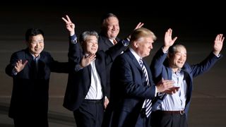 The three Americans formerly held hostage in North Korea gesture next to U.S.President Donald Trump and Secretary of State Mike Pompeo