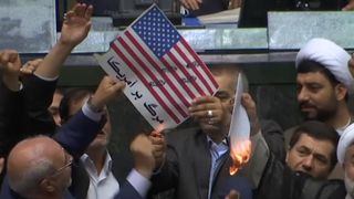 Iranian lawmakers have set fire to a paper US flag in the parliament in Tehran
