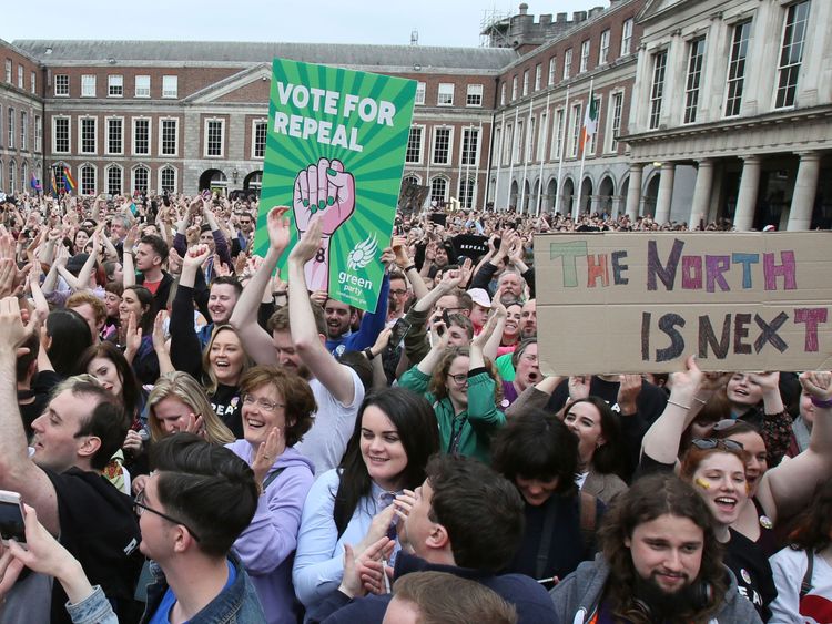 Yes campaigners hold posters calling for Northern Ireland to liberalise its strict abortion laws