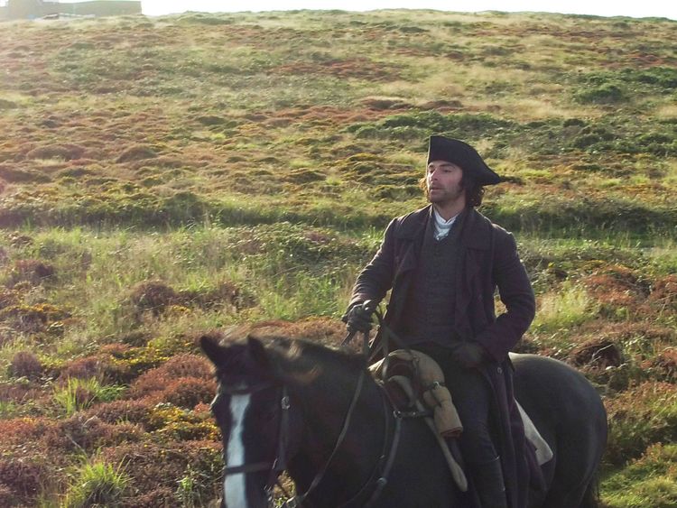 Poldark star Aidan Turner during filming at Gwennap Head on the Cornish coast