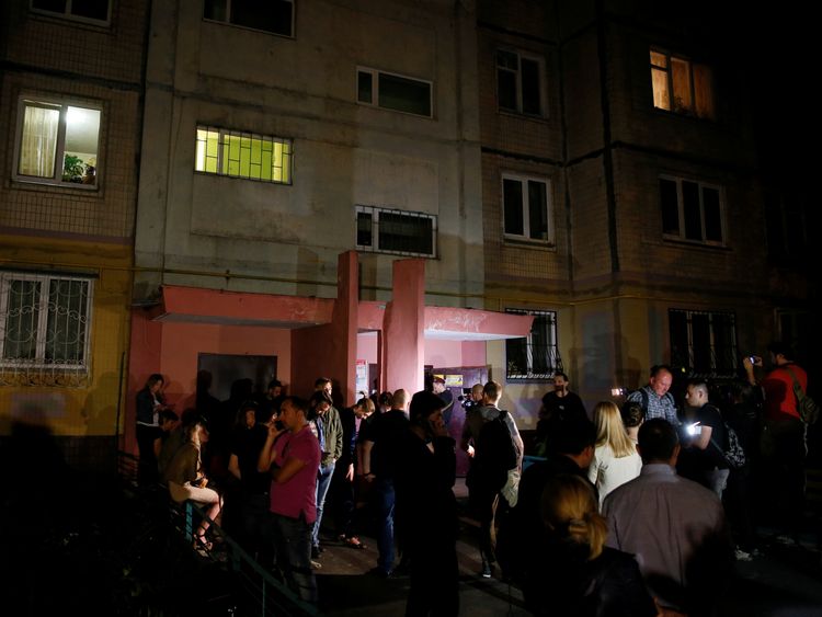 People gather outside the apartment building where Arkady Babchenko was shot 
