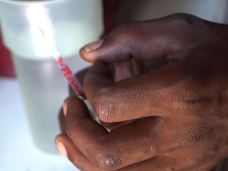 The addicts reinject the blood of someone who's taken a hit into their own arm