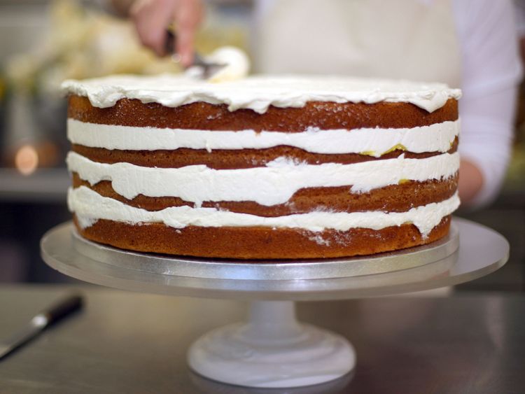 Claire Ptak, owner of Violet Bakery in Hackney, east London, puts finishing touches to the cake for the wedding 