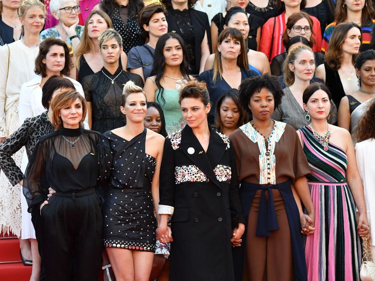 Directors, actresses and industry representatives pose on the red carpet in protest of the lack of female filmmakers honored throughout the history of the festival at the screening of 'Girls Of The Sun (Les Filles Du Soleil)' during the 71st annual Cannes Film Festival at the Palais des Festivals on May 12, 2018 in Cannes, southeastern France. - Only 82 films in competition in the official selection have been directed by women since the inception of the Cannes Film Festival whereas 1,645 films