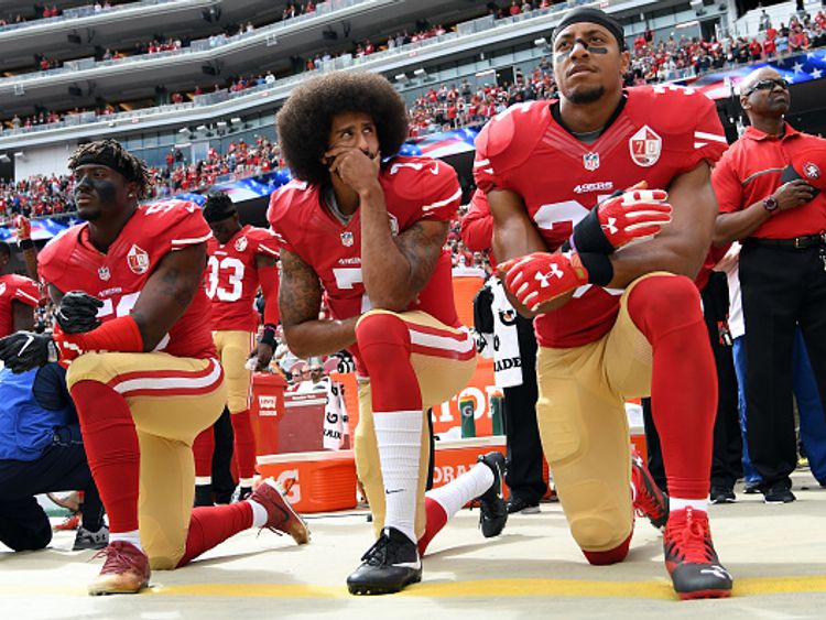 Colin Kaepernick, centre, started the kneeling protest movement in 2016 pre-season match