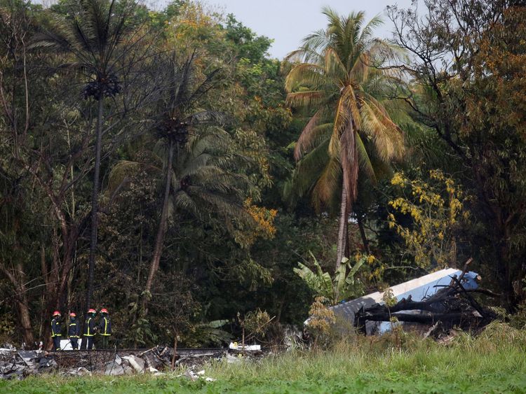 Firefighters work at the wreckage site of a Boeing 737 