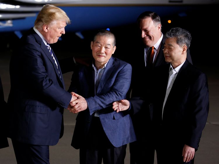 Donald Trump greets the Americans formerly held hostage in North Korea upon their arrival at Joint Base Andrews