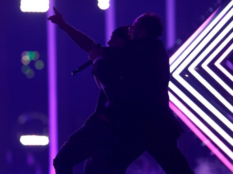 Security subdues a person who invaded the stage as United Kingdom's SuRie performed "Storm" during the Grand Final of Eurovision Song Contest 2018 at the Altice Arena hall in Lisbon, Portugal, May 12, 2018. REUTERS/Pedro Nunes