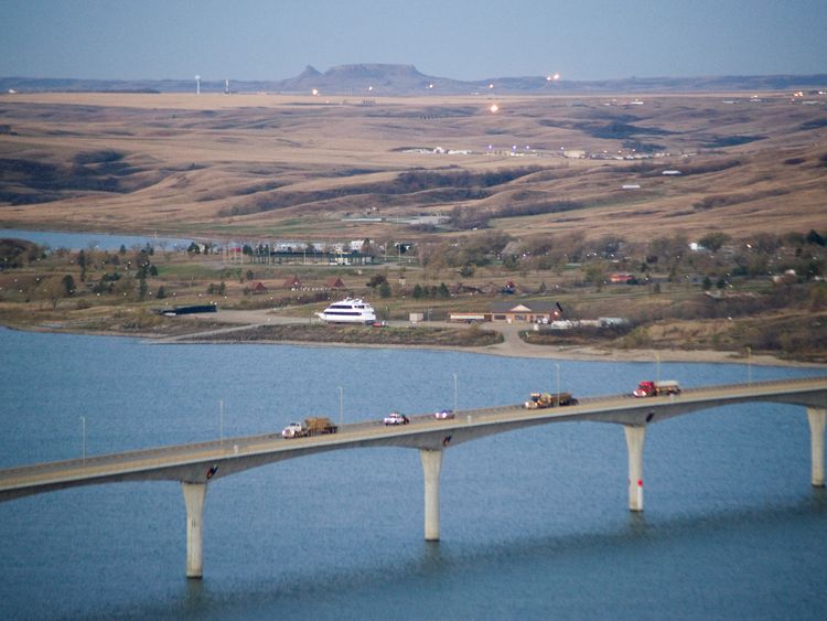Flares and lights from oil wells dot the horizon on the Fort Berthold Indian Reservation, just over the Missouri River from New Town, North Dakota in a November 1, 2014 file photo