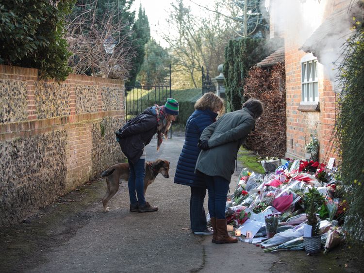 Flowers have mounted up outside the home in Oxfordshire home where Michael died
