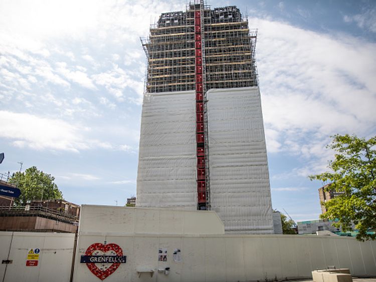 Scaffolding has been erected around Grenfell Tower, with covering partially concealing the burnt structure