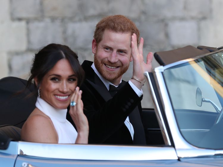  Prince Harry, Duke of Sussex, (R) and Meghan Markle, Duchess of Sussex, (L) leave Windsor Castle in Windsor on May 19, 2018 in an E-Type Jaguar after their wedding to attend an evening reception at Frogmore House. (Photo by Steve Parsons / POOL / AFP) (Photo credit should read STEVE PARSONS/AFP/Getty Images)