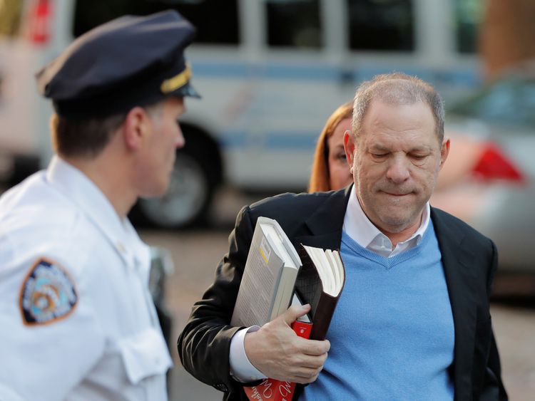 Harvey Weinstein was carrying two non-fiction hardbacks and a leather-bound book as he prepared to face police