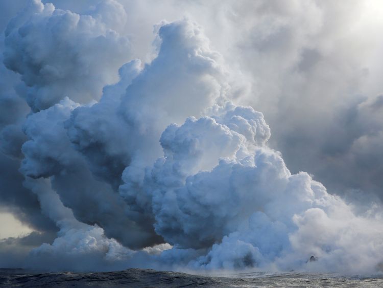 Clouds of toxic steam filled with shards of glass are forming as lava hits the sea