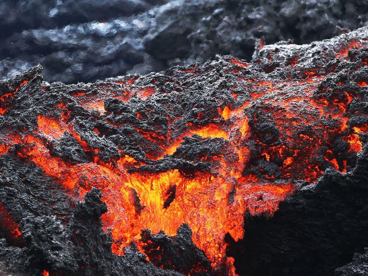 Lava flows at a lava fissure in the aftermath of eruptions from the Kilauea volcano on Hawaii's Big Island, on May 12, 2018 in Pahoa, Hawaii