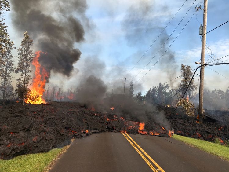 Lava advances along a street near a fissure in Leilani Estates, on Kilauea Volcano's lower East Rift...
