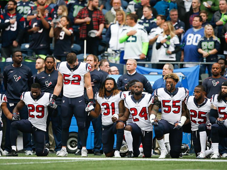 Members of the Houston Texas kneel before their games at the Seattle Seahawks