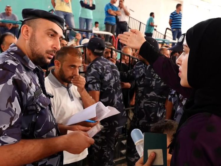 Palestinians try to get on a bus for Egypt after the border was opened in a rare treat