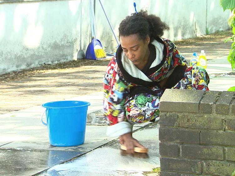 Pretana Morgan washes away blood from the floor after her 17-year-old son Rhyhiem Ainsworth Barton shot dead