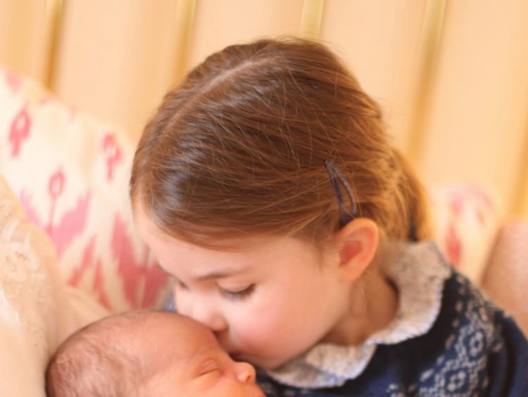 Princess Charlotte holding Prince Louis on her birthday