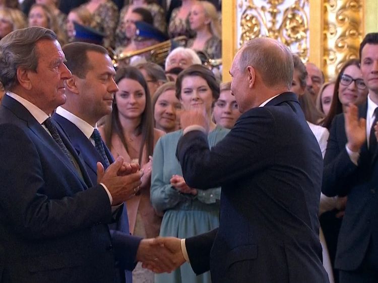 Putin shakes the hand of prime minister Medvedev