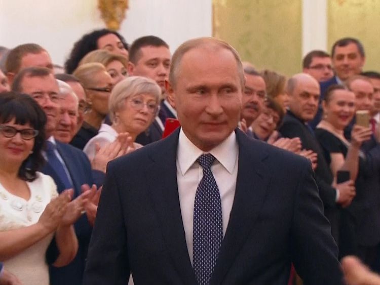 Putin smiles at attendees in the Great Kremlin Palace