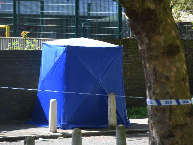 A forensic blue tent at the scene where the 17-year-old victim was found with a fatal gunshot wound