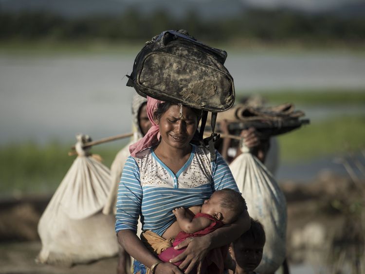 PSHOT - Rohingya refugee cries as she walks after crossing the Naf river from Myanmar into Bangladesh in Whaikhyang on October 9, 2017. A top UN official said on October 7 Bangladesh&#39;s plan to build the world&#39;s biggest refugee camp for 800,000-plus Rohingya Muslims was dangerous because overcrowding could heighten the risks of deadly diseases spreading quickly. The arrival of more than half a million Rohingya refugees who have fled an army crackdown in Myanmar&#39;s troubled Rakhine state since Augu