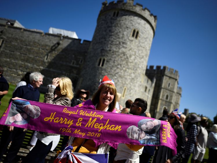 woman holds up a commemorative scarf during rehearsals for the wedding of Britain's Prince Harry and Meghan Markle