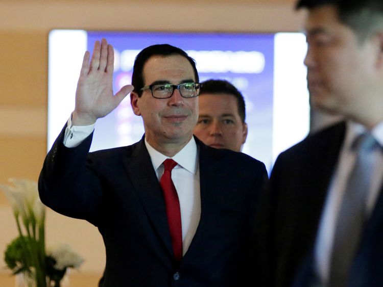 U.S. Treasury Secretary Steven Mnuchin waves to the media as he and the U.S. delegation for trade talks with China, leave a hotel in Beijing, China May 3, 2018.
