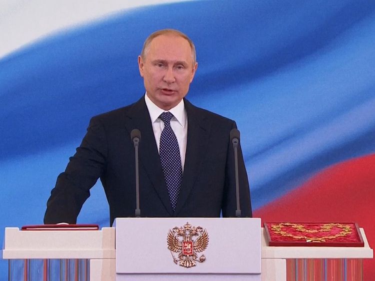 Vladimir Putin is sworn in at the lectern