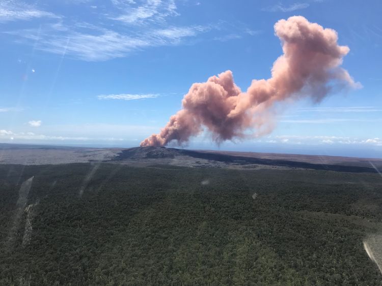 A plume of ash rises from Kilauea Volcano, one of five on the island, after a series of earthquakes