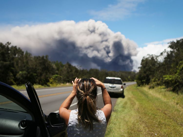 A massive plume of ash rises from the volcano