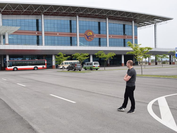 Sky News Asia correspondent Tom Cheshire looks at Kalma Airport in Wonsan. Pic: Michael Greenfield