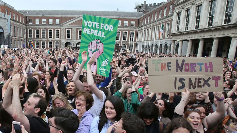 Yes campaigners hold posters calling for Northern Ireland to liberalise its strict abortion laws