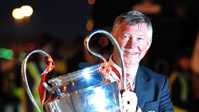 Manchester United manager Alex Ferguson holds the Champions League trophy on May 22, 2008 as he returns to Manchester Airport from Moscow after beating Chelsea on May 21 in the UEFA Champions league final, Manchester north-west England