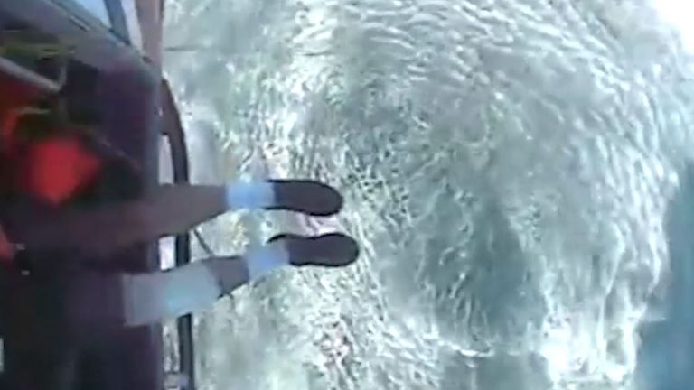 The fisherman can be seen with a bandage on his right leg after the rescue
