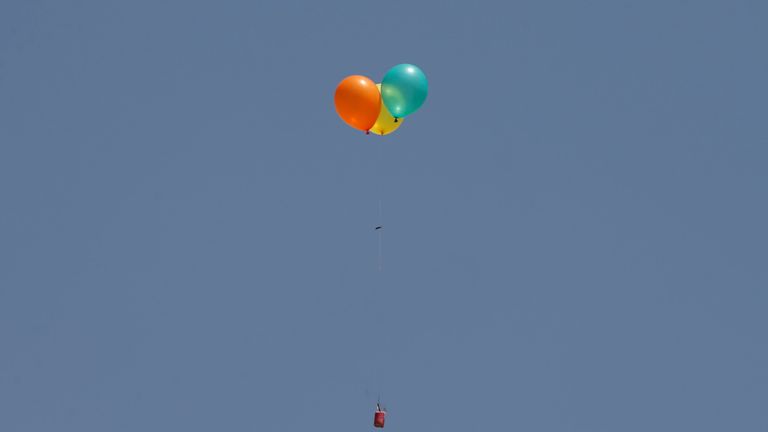 Flaming balloons are released by Palestinian demonstrators to the Israeli side 