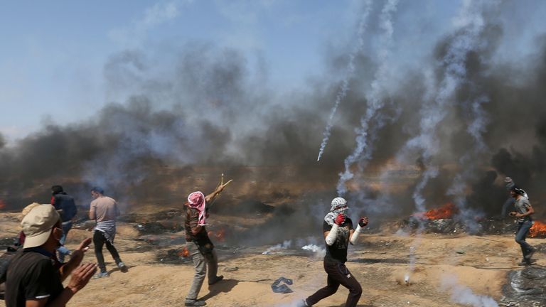 Tear gas canisters are fired by Israeli forces at Palestinian demonstrators