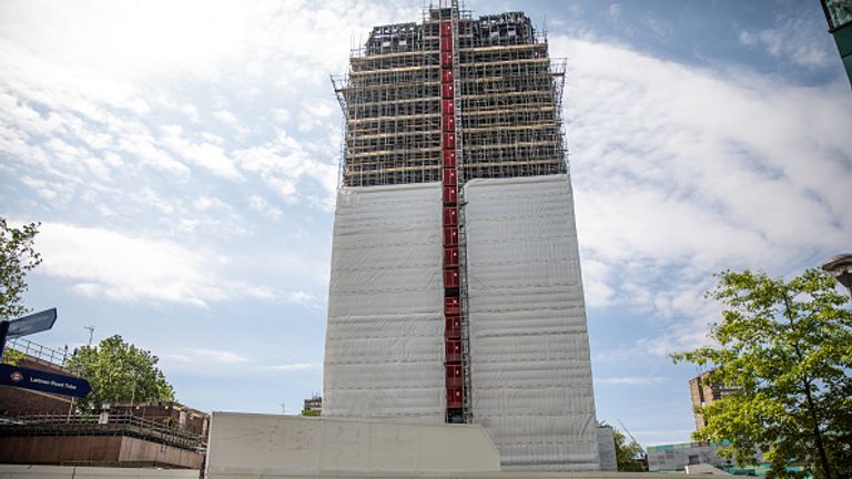 Scaffolding has been erected around Grenfell Tower, with covering partially concealing the burnt structure