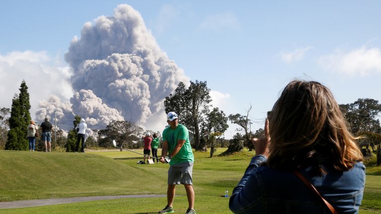 Sean Bezecny, 46, of Houston, Texas, played golf as ash erupted from the Halemaumau Crater 