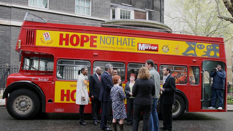 Prime Minister Gordon Brown (3rd from left) meets war veterans and actor Jason Isaacs (left) as he stands by the Hope Not Hate bus in London during his campaign for the forthcoming local elections.
