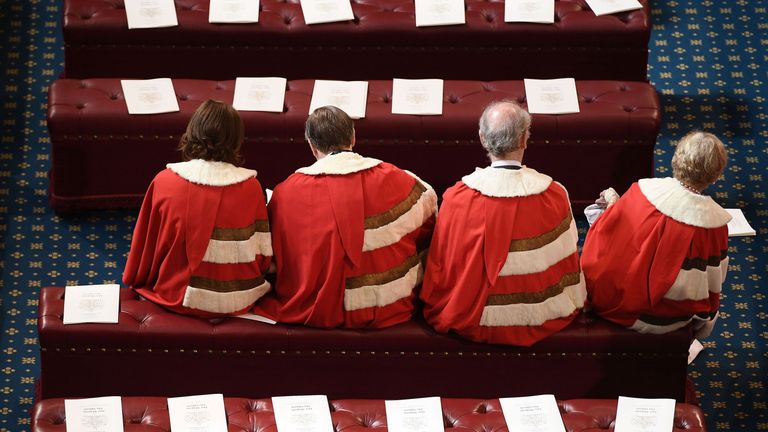 LONDON, ENGLAND - JUNE 21:  Peers find their places in the House of Lords before the State Opening Of Parliament at Houses of Parliament on June 21, 2017 in London, England. This year saw a scaled-back State opening of Parliament Ceremony with the Queen arriving by car rather than carriage and not wearing the Imperial State Crown or the Robes of State.  (Photo by Carl Court - WPA Pool/Getty Images)