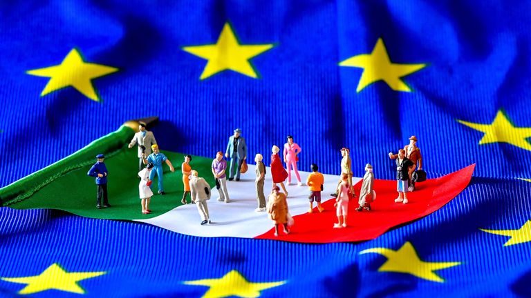 A picture taken on May 30, 2018 shows figurines on an Italian flag lying on a European Union flag